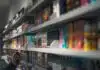 woman in black shirt standing in front of store shelf