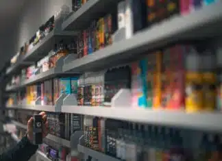 woman in black shirt standing in front of store shelf