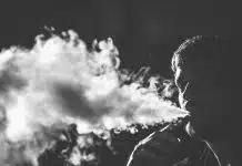 grayscale photography of smoking man