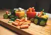 sliced carrots and green bell pepper on brown wooden chopping board