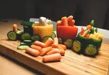 sliced carrots and green bell pepper on brown wooden chopping board